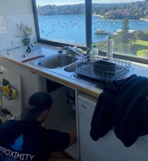 Fixing a slow-draining kitchen sink under the bench
